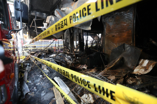 5일 오후 화재 피해를 입은 대구시 중구 서문시장 4지구에서 경찰이 폴리스라인으로 시민들의 접근을 막고 있다. 4지구는 지난달 30일 큰불이 나 사흘 만에 꺼졌다.